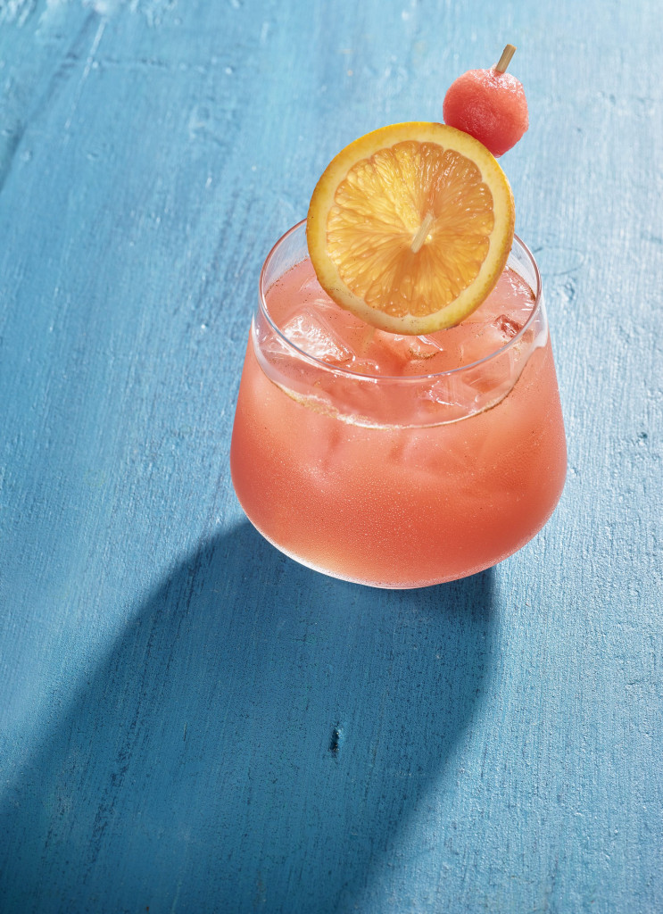 watermelon cocktail with ice, orange slice and watermelon ball